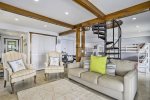 Ground level family room has a seasonal wood burning fireplace, laundry room, sitting area, sleeping area, and beautiful views
